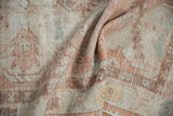 Distressed vintage Oushak runner, showing worn pile texture in antique ivory and pale apricot.