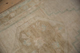 Vintage distressed Oushak rug with even short pile, curvilinear sand and seafoam design.