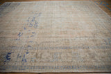 Worn, distressed texture of the vintage Oushak rug, showing faded cobalt blue geometric motifs.