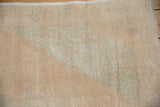 Distressed vintage Oushak rug: worn cream, beige, seafoam green pile with visible foundation.