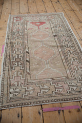Distressed vintage Oushak runner's primitive geometric border, with softened tones.