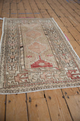 Distressed vintage Oushak rug, faded dusty rose medallion with primitive geometric charcoal border.