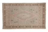 Vintage distressed Oushak rug, pale seafoam green field, dusty rose medallion, scattered floral elements.