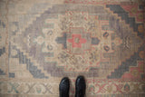 Abrashed field of a distressed vintage Oushak rug with stepped geometric patterns.