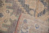 Distressed vintage Oushak rug pile with geometric pattern, abrashed field, and intact selvage.