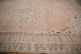 Distressed vintage Sparta carpet border with geometric motifs and subtle scrolling arabesques in pink, beige.