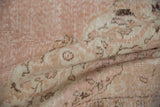 Distressed vintage Sparta carpet showing mostly even wear, soft pink, beige, and brown blossoms.