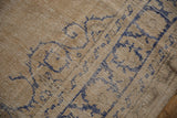 Distressed Oushak pile with cream, sand tones and cobalt blue scrolling floral arabesques.