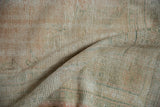 Textured low pile of a distressed Oushak rug with even wear across its hand-knotted surface.