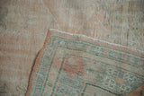 Hand-knotted weave on the reverse of a vintage Oushak rug with a secured side cord.