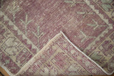 Intact side cord selvage and hand-knotted foundation of a distressed vintage Turkish Oushak rug.