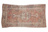 Vintage distressed Oushak rug runner with a stepped center medallion in faded blush, mauve, and silver tones.