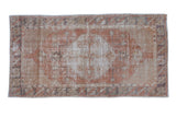 Distressed vintage Oushak rug runner with a roundel center medallion in sandalwood, silver, and beige tones.