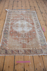 Angled view of a distressed Oushak runner with a soft, low pile and faded central medallion.