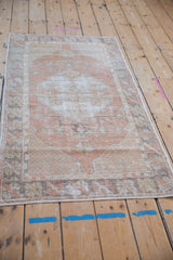 Angled perspective of a vintage distressed Oushak runner, highlighting its soft, worn texture.