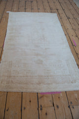 Distressed Oushak runner texture, showing faint pattern in ivory and beige tones.