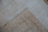 Vintage Oushak rug runner showing distressed beige pile and hand-knotted foundation.