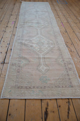 Distressed low pile and muted geometric floral pattern of the vintage Oushak runner.