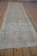 Distressed vintage Oushak runner texture, showing faint foundation and geometric floral patterns.