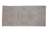 Vintage distressed Turkish Oushak runner with double medallion, floral guls in ivory, pale brown, and dusty blue.