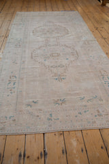 Vintage distressed Oushak runner edge, showing even wear, faint foundation, and dusty turquoise motifs.