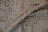 Distressed Oushak rug pile texture with ivory, pale coffee brown, and dusty turquoise guls.