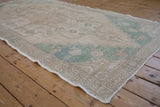 Evenly worn low pile and intact side cord selvage on a distressed vintage Oushak runner.