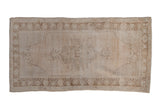 Distressed hand-knotted Oushak runner, ivory and pale coffee brown central medallion.