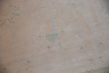 Distressed Oushak rug pile texture with even wear, ivory, seafoam green, and mauve abrashes.