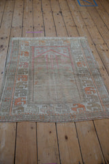 Vintage distressed Oushak rug, pale ruby red prayer mehrab with floral blossom border.