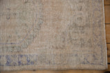 Hand-knotted pile of a distressed Oushak rug, showing wear to the foundation and visible knot heads.