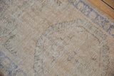 Detailed view of the distressed low pile showing visible knot heads and hand-knotted texture.
