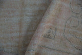 Vintage Oushak rug foundation showing hand-knotted construction and distressed texture.