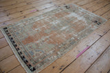 Distressed Oushak rug detail with abrash field, tattered fringe, and geometric charcoal border.
