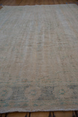 Distressed vintage Oushak carpet texture, revealing wear to foundation and faint teal details.