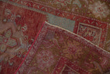 Folded Vintage Distressed Anatolian rug, revealing worn cherry red pile and hand-knotted foundation.