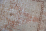 Close-up of the vintage Oushak rug's distressed texture showing even wear to the knot heads.