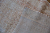 Hand-knotted construction and distressed, low-pile surface of the vintage Oushak runner.