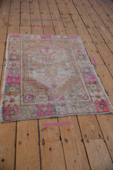 Distressed Oushak rug's pile texture with hot pink, beige, and visible knot heads.
