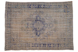 Vintage distressed Oushak carpet with a bold cobalt blue medallion on a time-softened ivory field.
