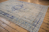 Worn pile of a vintage Turkish Oushak carpet with its cobalt and denim blue floral border.