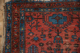 Vintage Lilihan rug corner, sapphire blue geometric border, raspberry field, tattered fringe.