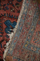 Vintage Lilihan rug reverse, showing red, blue, ivory foundation threads and tattered fringe.