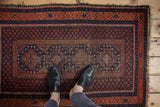 Terracotta and indigo blue Beshir rug with seed motif and stepped floral gul detail.