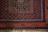 Vintage Beshir rug corner, terracotta and indigo geometric border with tattered ivory fringe.