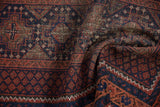 Close-up of vintage Beshir rug's madder root red, indigo pile and knot heads.