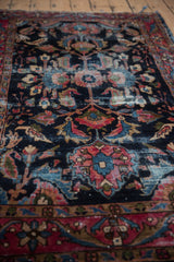 Vintage Lilihan rug's oversized floral cross-sections with navy, raspberry, sky blue pile.