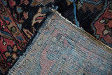Vintage Lilihan rug reverse showing blue, red hand-knotted foundation and worn floral pile.