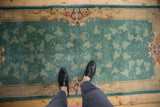 Feet on vintage Nichols runner, highlighting jade green scrolling vinery and Rococo border.