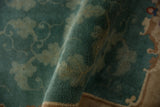 Dusty emerald green pile and light scrolling vinery pattern of a vintage Chinese Nichols rug.